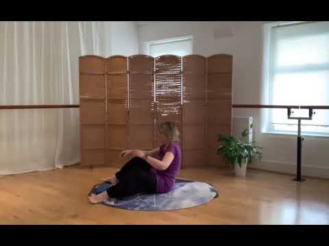 Asymmetrical Pilates class with a yoga block