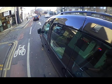 SL62ZSX - Physically pushes cyclist out of the lane