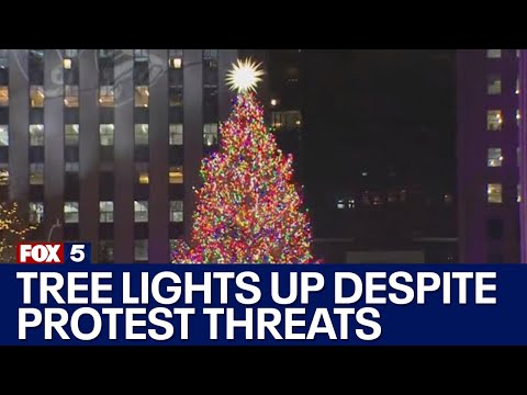 Rockefeller Christmas Tree lights up despite protest threats