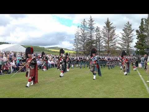 Drum Majors lead Massed Pipe Bands parade during  2022 Dufftown Highland Games in Moray Scotland
