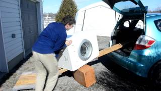 Unloading a washer from a car, alone