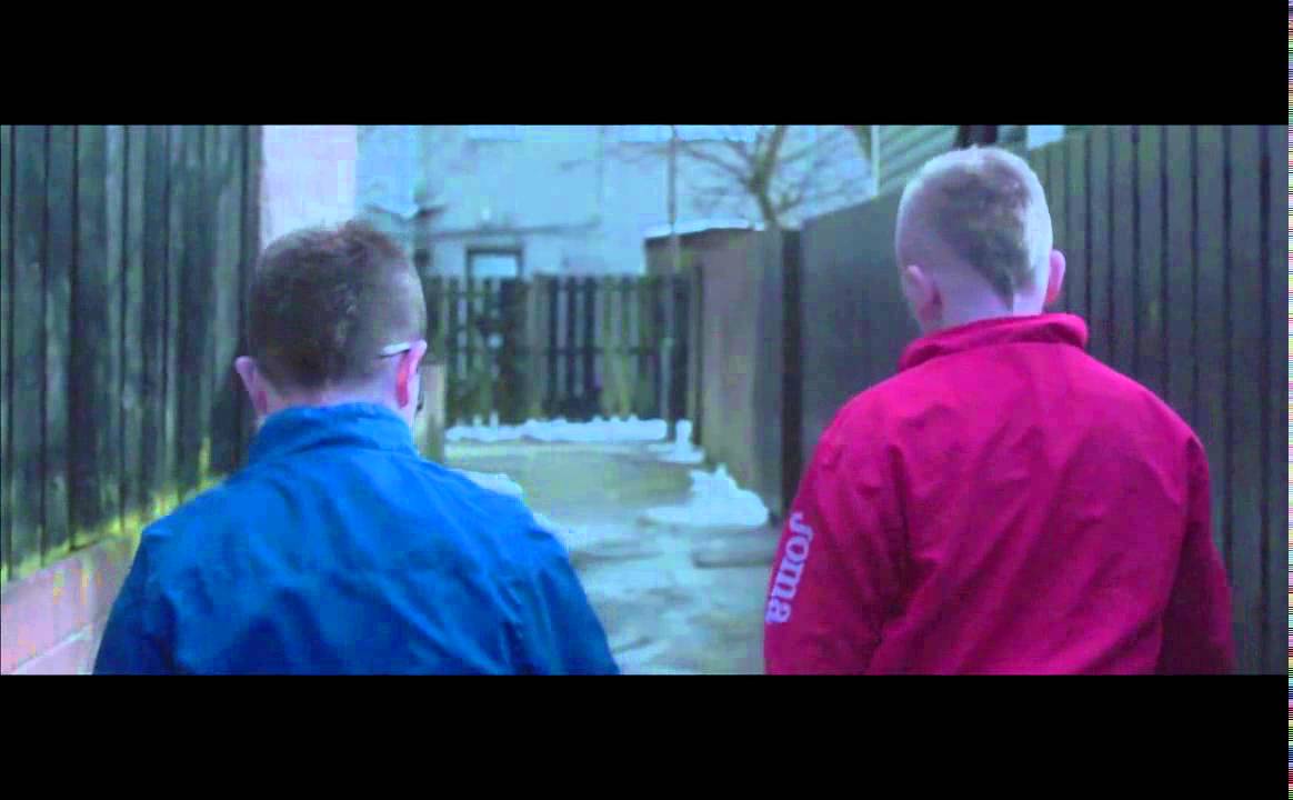 Still from Mo Chara: two boys in tracksuits walk away down a narrow alley