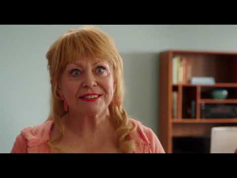Poms official trailer frame — Diane Keaton’s Martha watches the cheer squad form in a gym lit by halogen lights