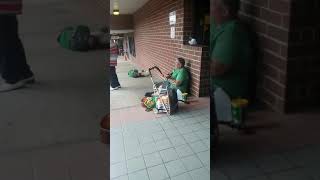 Two guys singing on the sidewalk