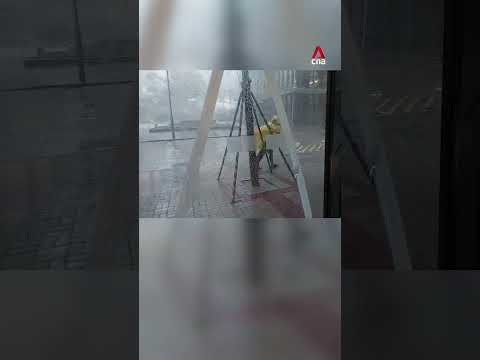 Hong Kong pedestrian struggles to walk as Typhoon Ragasa batters city