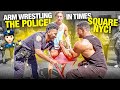 ARM WRESTLING TOURISTS AND POLICE OFFICERS IN TIMES SQUARE NEW YORK CITY!