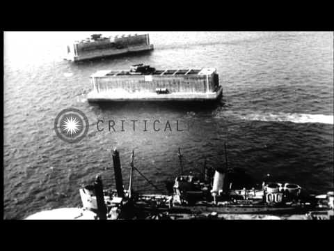 Construction of phoenix units, a Lobnitz pier head, and a pontoon bridge by the S...HD Stock Footage