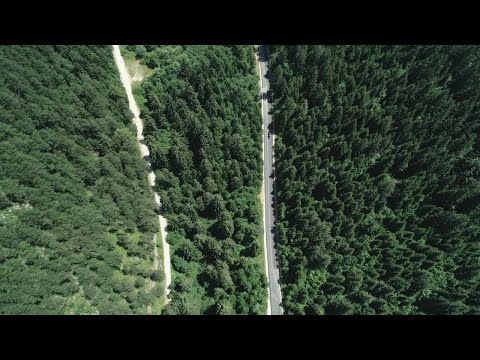 Blue Car Driving Through Mountain Stock Video