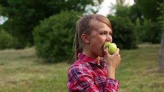 Girl biting an apple