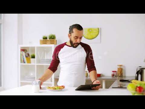 Man with Tablet Pc Eating Breakfast at Home 25 | Stock Footage - Videohive