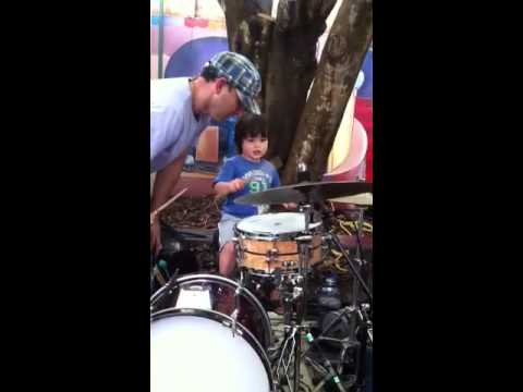 Adam Barry playing drums with Mark Moroney's band at Eumundi markets