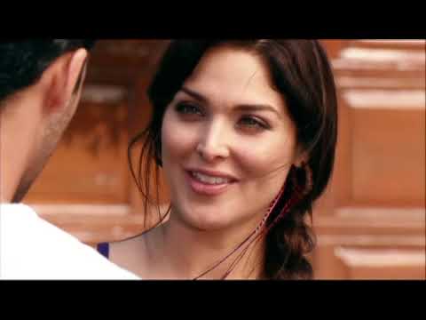 Trailer frame: close-up of a talisman pendant as strings and light percussion lift the mood