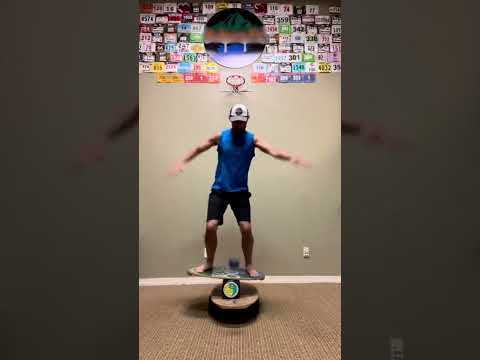 Athlete Demonstrates Indo Boarding Balancing Skills While Making Baskets - 1385838-1