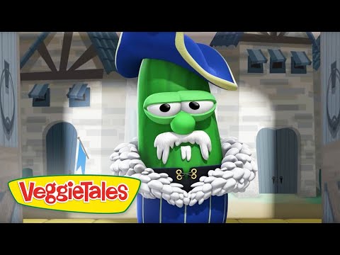 Green VeggieTales cucumber in a blue pirate outfit with a white fur collar, standing in a castle set with the VeggieTales logo.