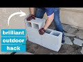He stacks cinder blocks in his front yard for a brilliant outdoor furniture idea!
