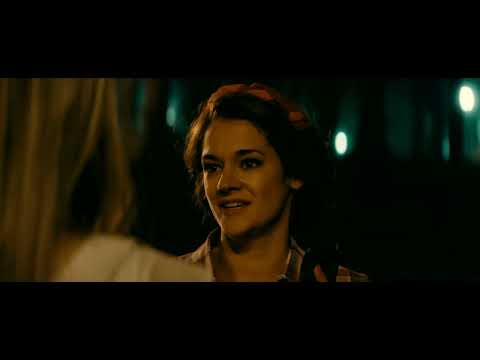 Trailer still: backyard barbecue where bright pop plays over uneasy small-town smiles