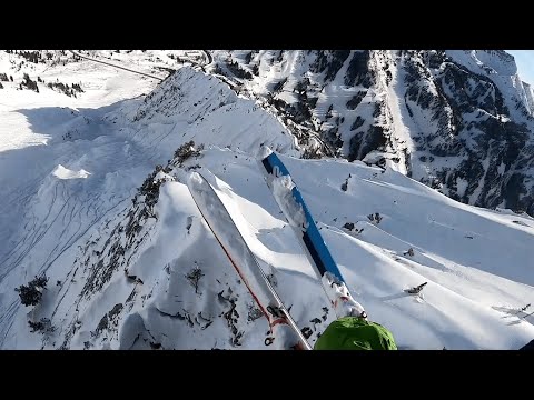 Brave skier speed flies over stunning alpine scenery in Utah.