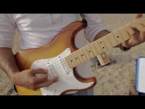 The Amazing Edgar Reyes playing his guitar off the PCH Mugu Rock Malibu CA