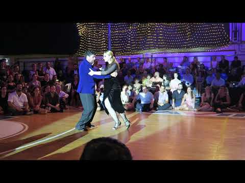  Fernando Sanchez  and  Ariadna Naveira  are  dancing  to  the  tango  "  El Choclo  "  by  Carlos di Sarli  at  A los amigos tango festival  in  2019