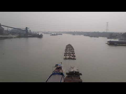 Tugboat carrying huge steel pipes