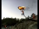 Viktor jumping into the water with burning umbrella