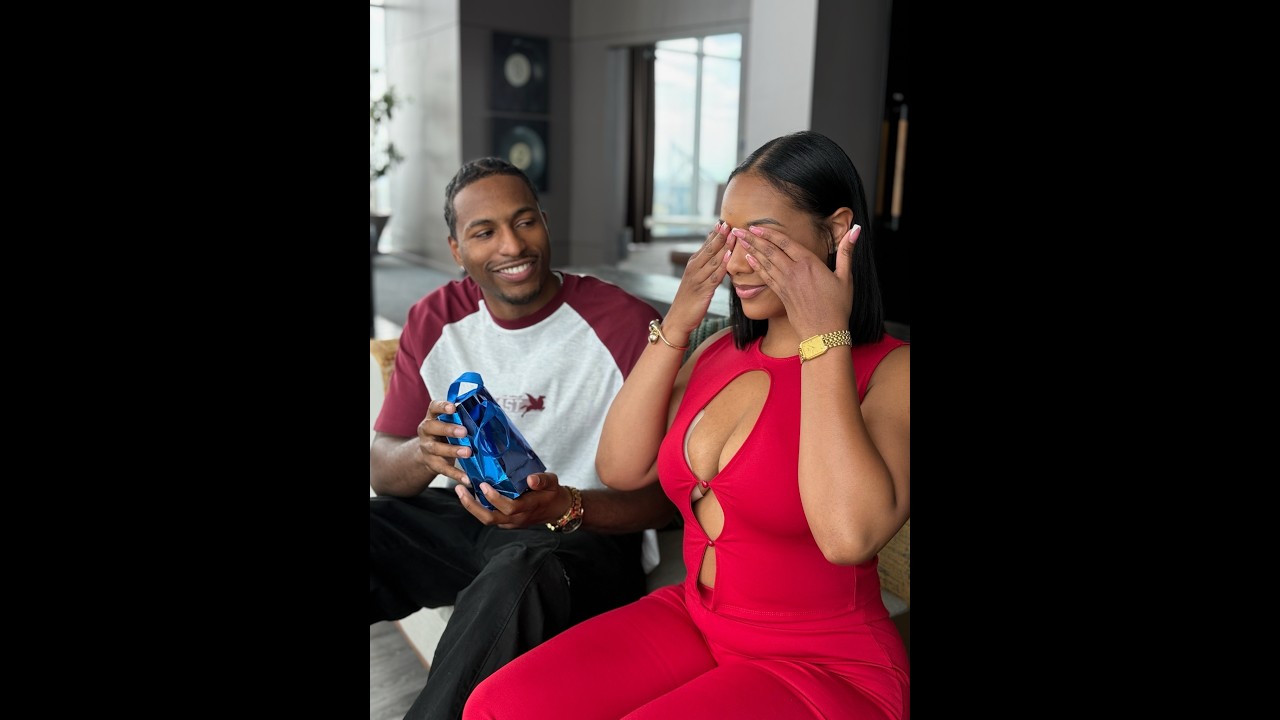 Tre surprises Ms. Johnson with a new bottle of perfume!