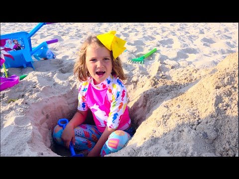 Max and Katy Playing on the beach with Daddy