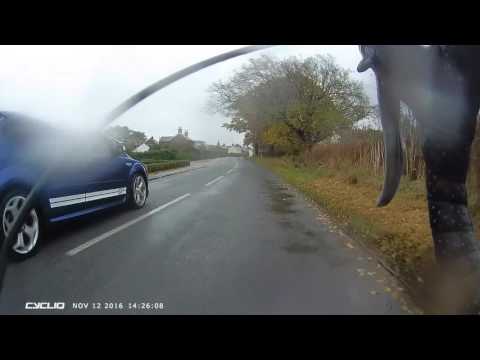 AK07YZO Ford Focus Brake Check On Cyclist