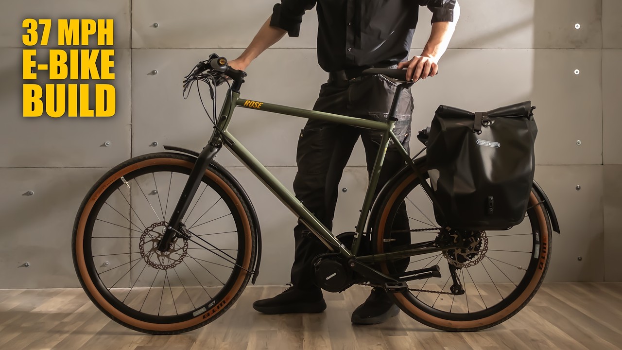 Custom-built e-bike commuter with rear panniers hiding the battery, parked on a Netherlands street looking like a standard road bike
