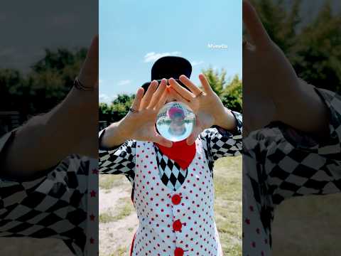 Elegant Circus Clown with Glass Ball – Hypnotizing Show at Company Picnic!