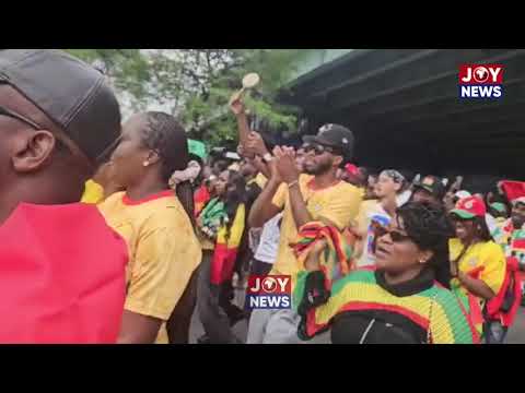 Ghanaians in Toronto march excitedly to the stadium ahead of the game.