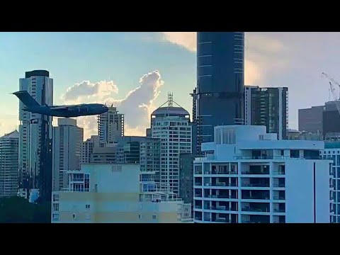 Crazy low flying jet through city buildings