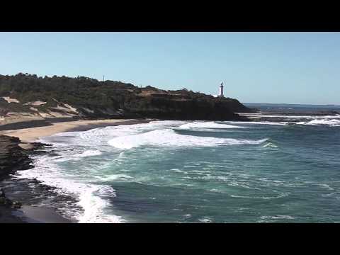 Solid swell crashing at Norah Head with surfers