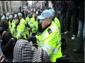 Riot police officer U1202 punches student in head.