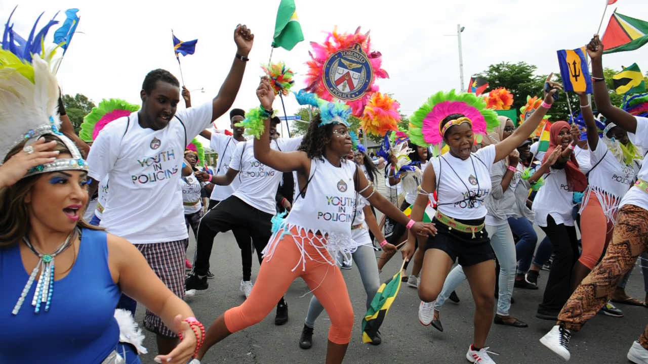 YIPI students and Service members have a dance party on Lake Shore Blvd. at the Carnival Grand Parade