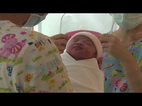 Newborns given tiny face shields at a Bangkok hospital