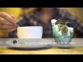Woman Putting Sugar Into Tea Cup Using Tongs