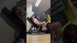 Guy Helps Friend When He Gets Cramp in Leg While Doing Leg Press at Gym - 1313688