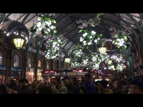 Juggler juggling while on big ball London Covent Garden UK