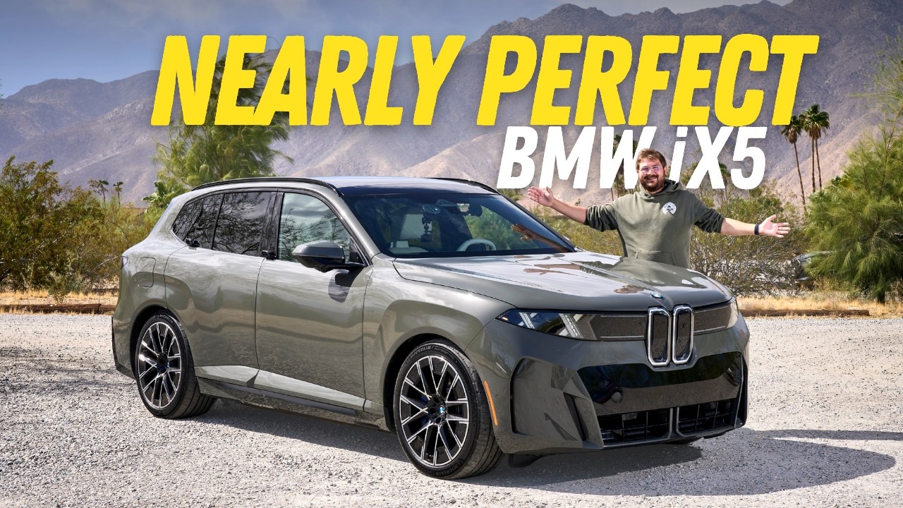 BMW iX5 electric SUV driving on a mountain road