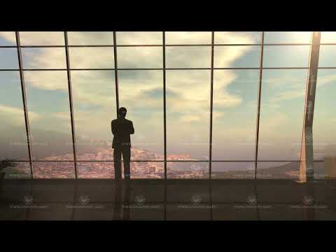A silhouette of a businessman standing in front of a window from dawn to dusk.