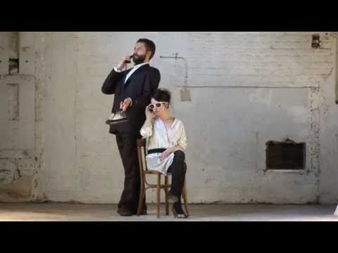 A MAN STANDING BEHIND A SEATED WOMAN  Stav YEINI and Veli LEHTOVAARA