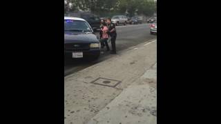 LAPD officers try to restrain a guy in drugs who was previously walking inside a middle school