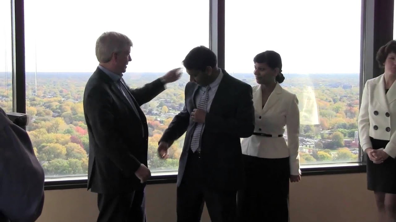 Rick Snyder greets Tel Ganesan and Rupesh Srivastav