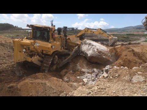 Caterpillar D9T Bulldozer Pushing Huge Concrete Blocks