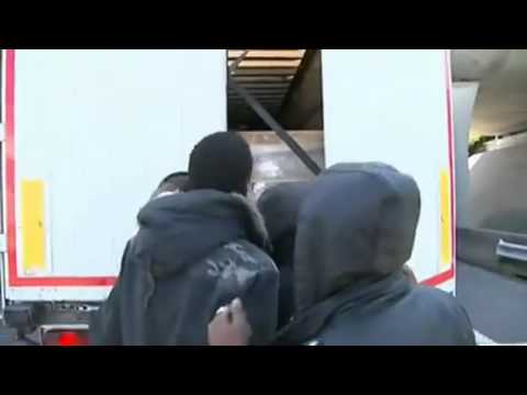 VIDEO - Calais migrant crisis: Moment man climbs into lorry cabin new
