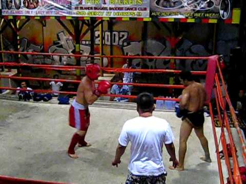 Tourist vs thai boxer fighting in thailand bar round 1