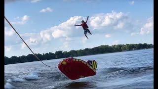 Kid ejected off tube behind surf boat (slow motion)