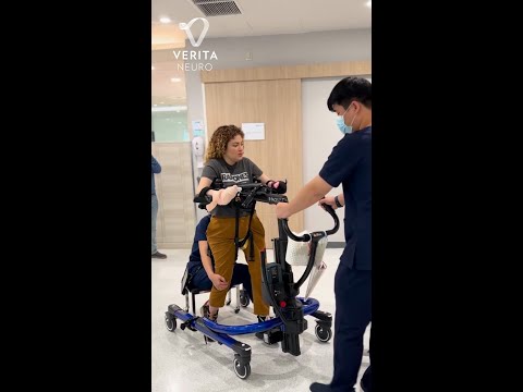 Greta, C5-C6 spinal cord injury patient, taking steps in E-walker.