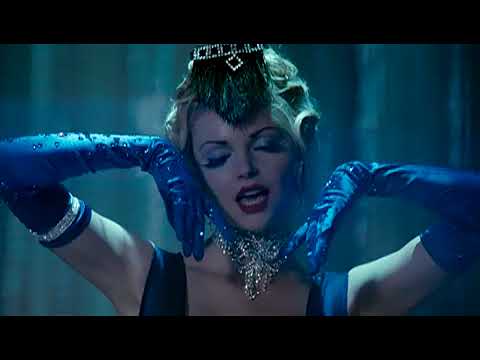 Dark Streets trailer frame: horn section and dancers in feathers mid-number